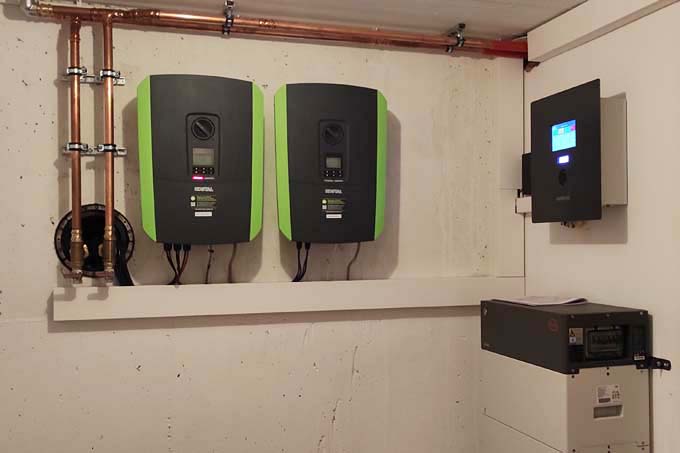 Links sind zwei Wechselrichter für die PV-Anlage. Rechts steht der 10 kW Batteriespeicher und darüber ist die Steuereinheit angebracht. - Foto: Vera Schloßbauer